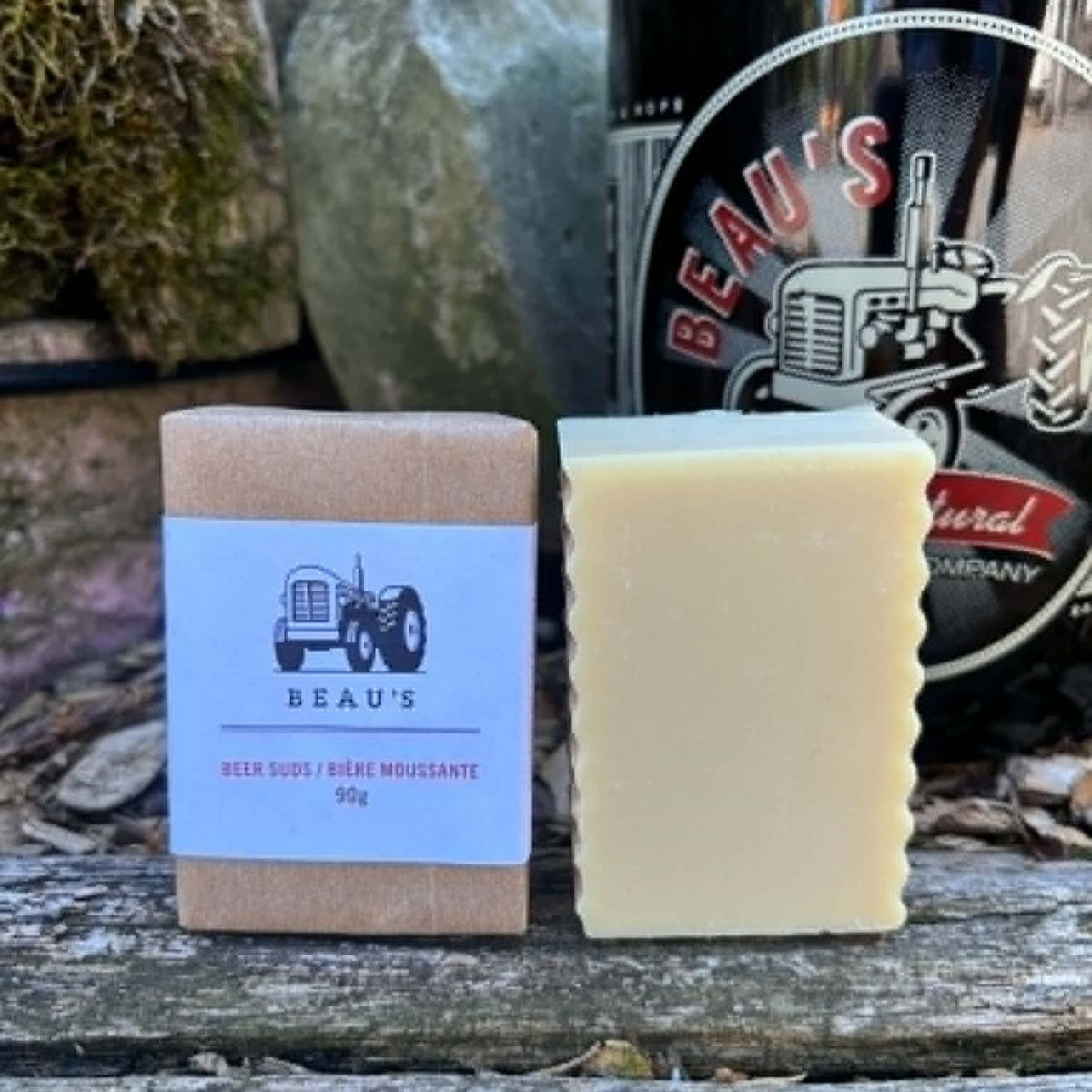 Beau's Beer Suds Bar of soap with a bottle of Beau's beer on a wooden surface by Garden Path Homemade Soap. 100% Natural . Made with Beau's Beer