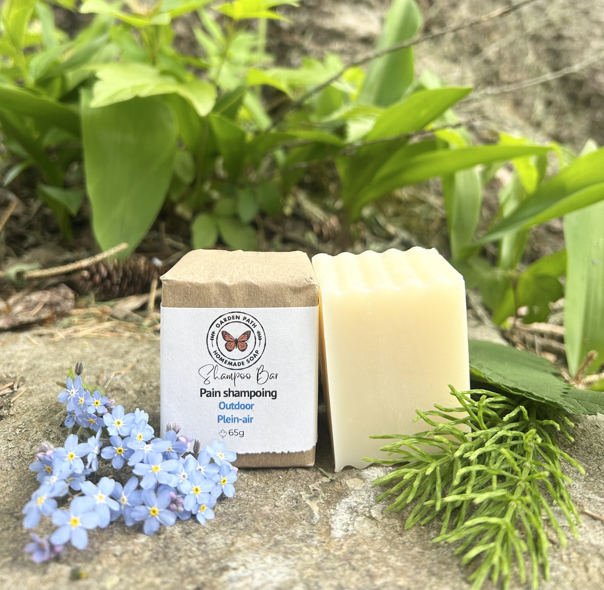 Outdoor Shampoo Bar of soap and packaging on a natural background with greenery and flowers by Garden Path Homemade Soap