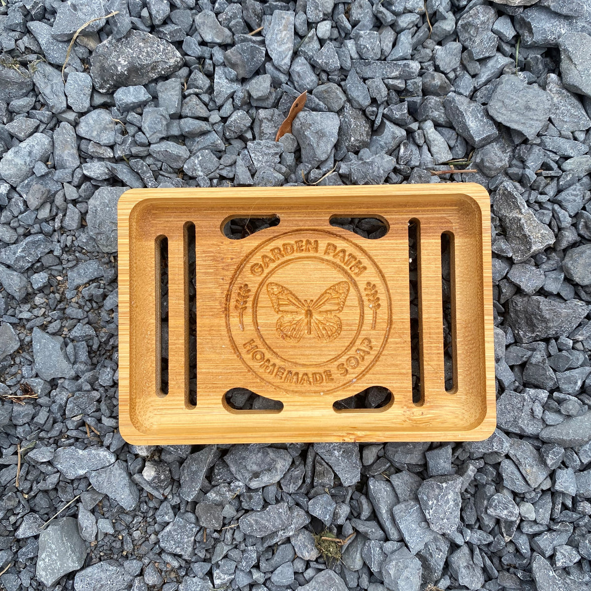 Single Bamboo Soap Dish with Garden Path Homemade Soap label in the bottom of one side. Slats in the bottom of the dish for drainage.