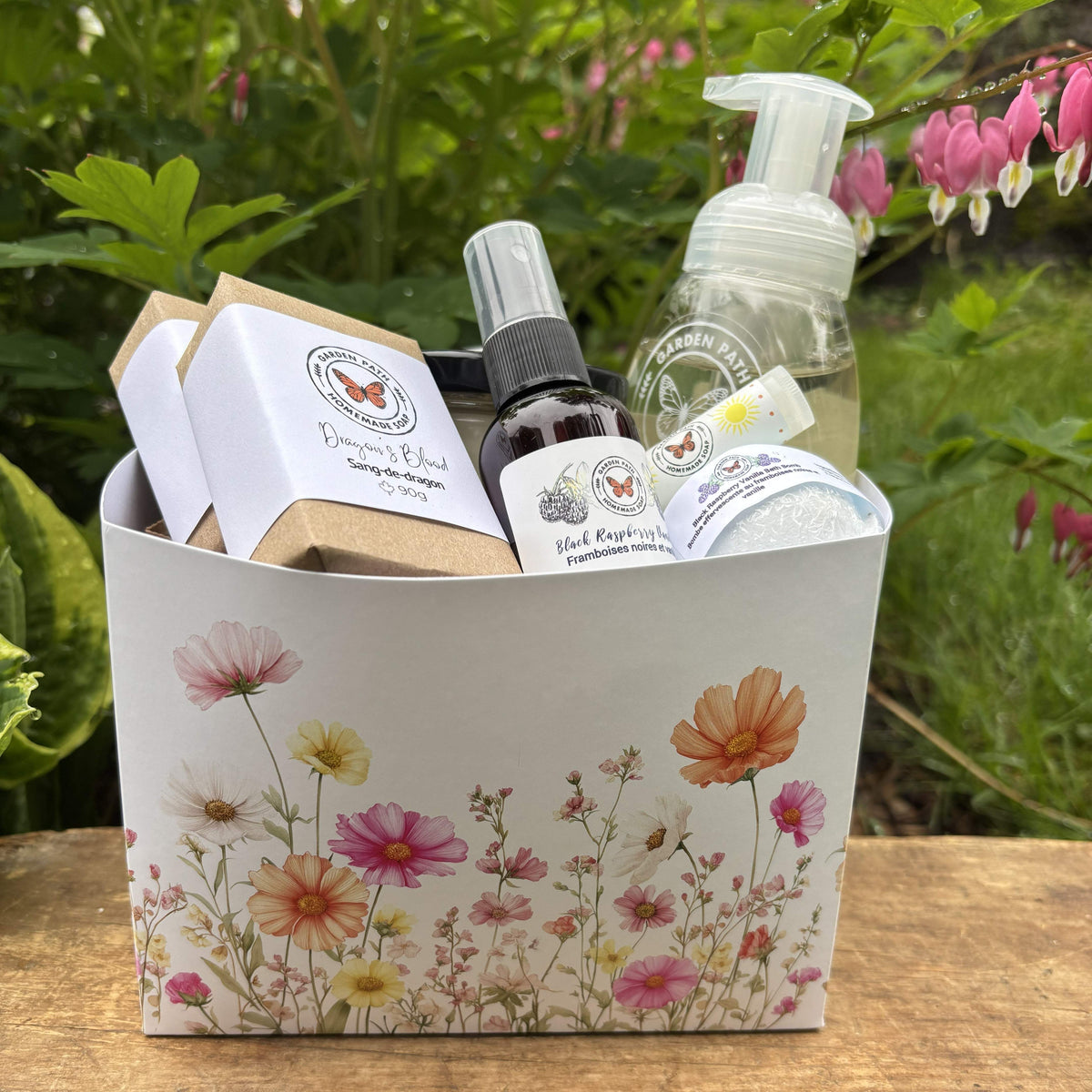 bar soaps, room spray, lip bomb, bath bomb and foaming hand soap in a floral decorated gift box