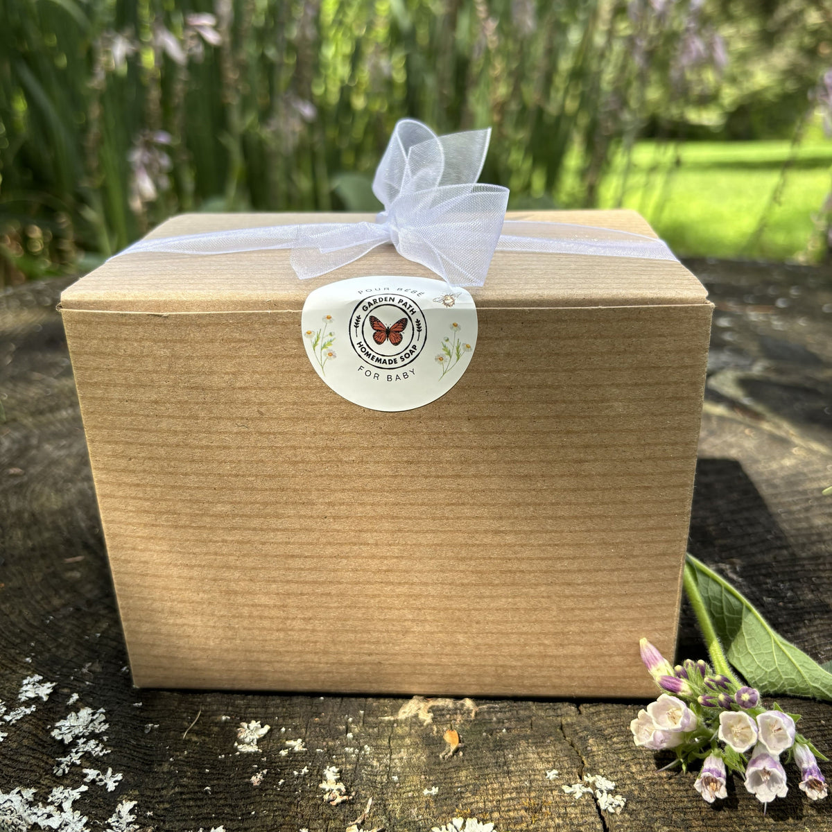  Garden Path Homemade Soap's Wiggle Baby Bundle packaged in a box with a ribbon tied around it with a  butterfly logo sticker .