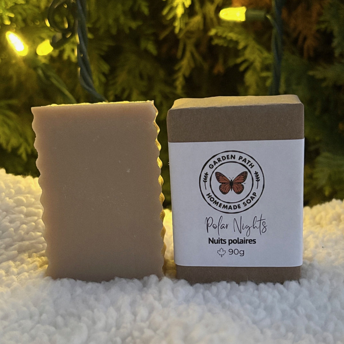 Polar Nights Bar Soap (limited time) on a white snowy surface with Chrismas lights in the back ground | Lightly Scented with Fragrance Oil - Garden Path Homemade Soap