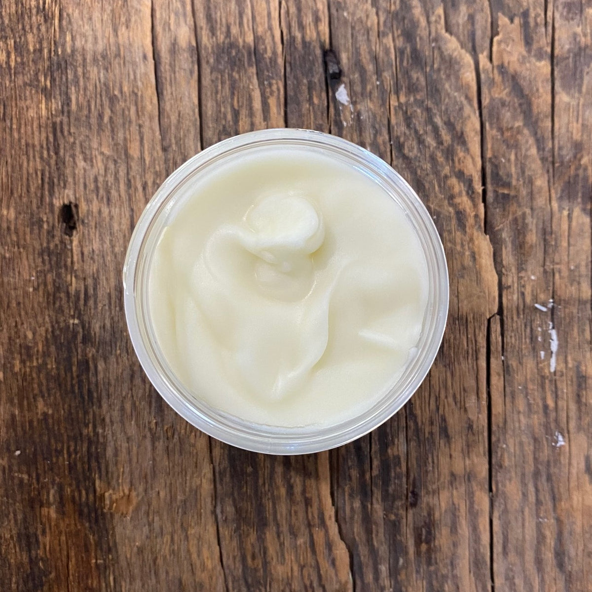Opened Lavender Moisturizing Hand Lotion jar on a wooden surface | 100% Natural Ingredients & Essential Oil - Garden Path Homemade Soap